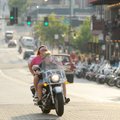  Two riders makes their way east on West Dickson Street during the second day of the Bikes, Babes & ...