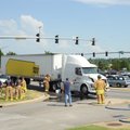  Fayetteville Fire Department personnel work Friday to contain a diesel spill at the intersection of...