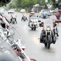 A group of motorcyclists ride east Saturday on West Dickson Street in a light rain on the third and ...