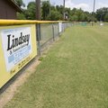  Signs line the outfield fence of one of the baseball fields Friday at Walker Park in Fayetteville. ...