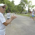 Jack Gentry of Rogers cheers Saturday for his grandson, Ben Mulvaney of Tennessee, right, during the...