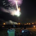  The Heasley family of Bentonville watches the Fourth of July fireworks display Sunday at Orchards P...