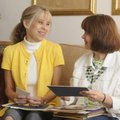 Kandy Johnson, left, and Kim Duell look Thursday through photographs and mementos of their time att...