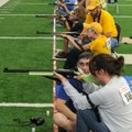  John Cummings, Pendleton, S.C., Anderson Aces coach, watches as shooter Emlynn Shoemaker, 14, fires...