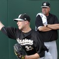 San Antonio pitching coach Glenn Abbott, right, watches as pitcher Corey Kluber works out before the...
