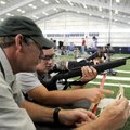Mike Jochum gives Patrick Gower, 16, a few tips on shooting during prep time before Gower had to sig...
