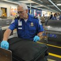 Jim Foy with the Transportation Security Administration inspects luggage Wednesday at Northwest Arka...