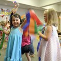 Breanna Pena, 3, waves to her mother Wednesday while singing and dancing during preschool story time...