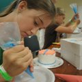 DECORATION CONCENTRATION - Adriana Joyce who lives near Bella Vista practices making flowers with ca...