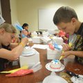 SWEET SUMMER - Autumn French, left, from Springdale and Andrew Campbell of Fayetteville work Thursda...