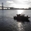 A police boat patrols Friday near the scene of Wednesday's collision that occurred between a sightse...