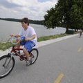 Jacob Sharits, 9, of Fayetteville, rides along the Lake Fayetteville Trail Monday July 5, 2010.