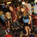 Justin Repass, 15, left, competes with Sarah Creasey, 14, in a dance arcade game as Jacob Bishop, 14...