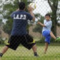 PRACTICE MAKES PERFECT - Xavier Serrano, 9, right, tries to get a shot past his uncle, Gustavo Soria...