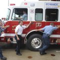 RED-HOT REPLACEMENT - Rogers firefighters push the new Engine No. 2 into a bay Friday at Station No....