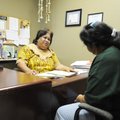 Sandy Joel, left, a Marshallese educator for Credit Counselling of Arkansas, speaks Thursday with cl...