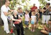 Mart Phillips of Dallas, left, places a tiara atop the head of his mother, Florene Phillips, to mark her 87th birthday Saturday during a family reunion at Battlefield State Park in Prairie Grove. The Phillips family has held 144 family reunions, one each month for the last 12 years, and hopes to establish a record with the Guinness Book of World Records. More photos at http://photo.nwaonline.com 
