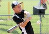 Bentonville’s Jay Austin, 14, swings away during a home run skills competition after Sunday’s opening ceremonies for the USSSA World Series at Phillips Park in Bentonville. Four days of play between 19 teams from five states starts at 9:30 a.m. today.