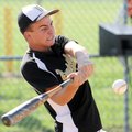 Bentonville’s Jay Austin, 14, swings away during a home run skills competition after Sunday’s openin...