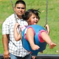 Kenisha Ramirez, 3, swings high in the air while spending quality time with her father, Presbitero R...