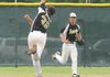 The Bentonville USSSA 14-year-old team’s John Michael Neubert makes a running catch of a high fly ball against the Arkansas Scorpions in the USSSA World Series on Monday at Phillips Park in Bentonville.