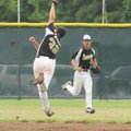 The Bentonville USSSA 14-year-old team’s John Michael Neubert makes a running catch of a high fly ba...