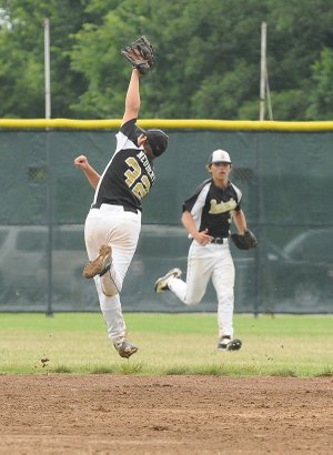 The Bentonville USSSA 14-year-old team’s John Michael Neubert makes a running catch of a high fly ball against the Arkansas Scorpions in the USSSA World Series on Monday at Phillips Park in Bentonville.