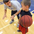 Rogers Mountie Alex Ryals, a junior, works on offensive tactics Monday with Spencer Terry, 9, during...