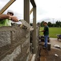 Jesse Hartin (from left) of Bella Vista, Bob Appleby of Bentonville and Keith Coody of Rogers work o...