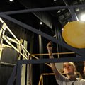 Allie Wolfe, 14, works on painting a section of the set Tuesday for The Village Players’ production ...