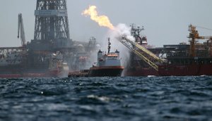 A work boat, center, operates near the Helix Producer, right, in the area of the Deepwater Horizon oil spill  on the Gulf of Mexico, Tuesday.