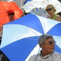 UNDER HIS UMBRELLA - August Synoground of Greenwood watches from under the shade of an umbrella Thur...