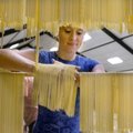 PREPPING PASTA - Megan Pearce racks freshly made spaghetti Thursday to dry in the parish hall at St....