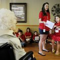 Angeline Wohlfert, left, listens as Kelly Williams, middle, reads a poem Friday written by Amanda Va...