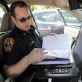 Officer Jamison Stiles shows a folder Thursday with all the warrants out for people in his patrol ar...