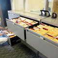 Amanda Crawford, communications coordinator with the Rogers Police Department, puts a warrant away T...