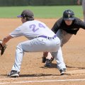 Bentonville’s Daulton Terry makes it back to first base while Fayetteville’s Jacob Pinta waits for t...