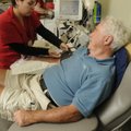 Maribel Chavez with the Community Blood Center of the Ozarks gets Gardiner Powell set up to donate p...