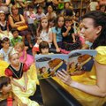 Dianna Blaylock reads to children as Belle from Disney’s “Beauty and the Beast” during a book day Sa...