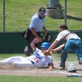 Fayetteville Lindsey’s Brandon Zamzow is tagged out Sunday by Mountain Home’s catcher during the Zon...