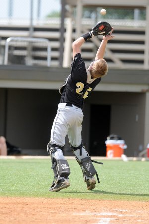 Bentonville catcher Daulton Terry grabs a foul for an out against Har-Ber in the Ozark Wood Bat Tournament on Sunday in Bentonville.
