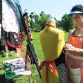 Leah Garrett, with Totes and More of Tontitown, displays one of her aprons for sale Sunday at the Fa...