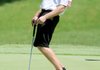 Clay Porch leans while his putt circles the edge of hole No. 18 on the Pinnacle Country Club Golf Course Sunday in Rogers. Porch was playing in the final round of the Red Hudson Invitational Golf Tournament.