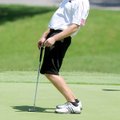 Clay Porch leans while his putt circles the edge of hole No. 18 on the Pinnacle Country Club Golf Co...
