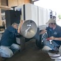 Larry Wade, left, and Chris Wade work to assemble a new special power washer Thursday at Springdale’...