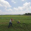 George McCawley mows grass Monday as temperatures hit the 90s at Agri Park in Fayetteville. The Nati...