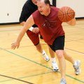Gary Garnett dribbles past Bill Hunthrop trying to score in a game of hoops in the air-conditioned b...