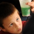 Ben Flowers, 8, looks at the bath gel he created Tuesday during a Summer Reading Program workshop at...
