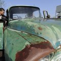 Robert Garza, owner of Hog City Customs in Springdale, power washes the cab of a 1958 Chevrolet truc...
