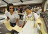 Kara Jo McKinley, left, and Jettie Franco roll pasta before it is cut into spaghetti and hung to dry on Thursday at St. Joseph Catholic Church parish hall. More than 40 volunteers worked to produce the first of four batches of spaghetti for dinners to be served Aug. 5-7 during the 112th Tontitown Grape Festival.